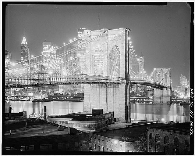22. Night view looking NW showing bridge lighted. Jet...