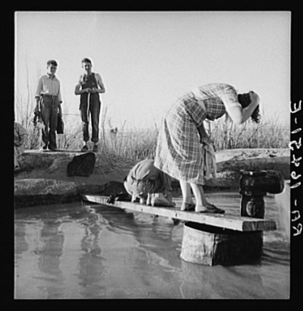 Oklahoma migratory workers washing in a hot spring in the...
