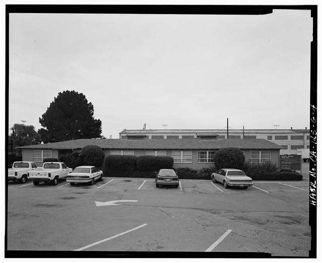 4. EAST FACE. VEGETATIVE SCREENS BUFFER THE BUILDING FROM...
