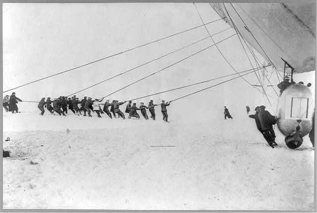Crew of the "Norge" hauling the giant airship out of the...