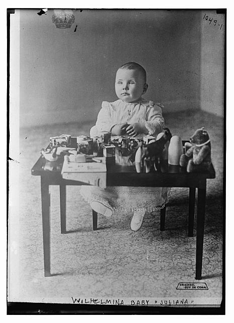 Juliana, Wilhelmina baby, seated at table of toys, Guy de...