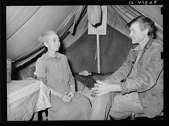 White migrant and his wife in camp near Sebastian, Texas....