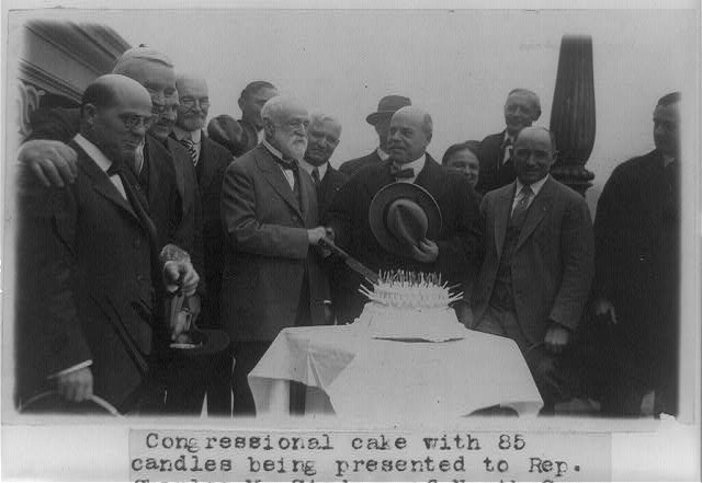 Congressional cake with 85 candles being presented to...