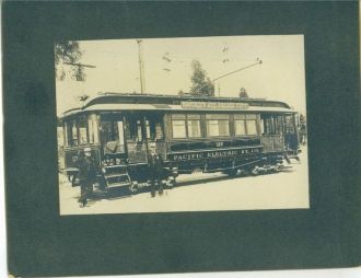 2 men in front of trolley Car