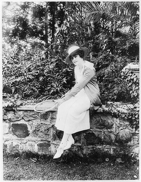 [M.E. Kahn, full-length portrait, facing left, seated on...