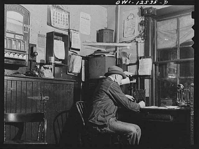 Chicago, Illinois. Train clerk working on his lists in...