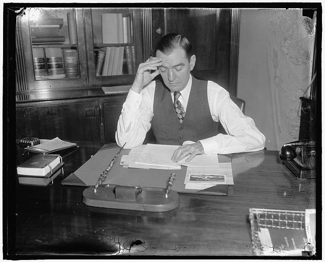 Congressman's day. 11:00 A.M. Rep. Thomas studies the...