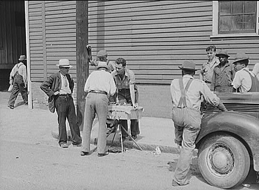 Peddler selling patent medicines to farmers outside...