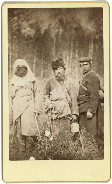 Three run away convicts standing in a field