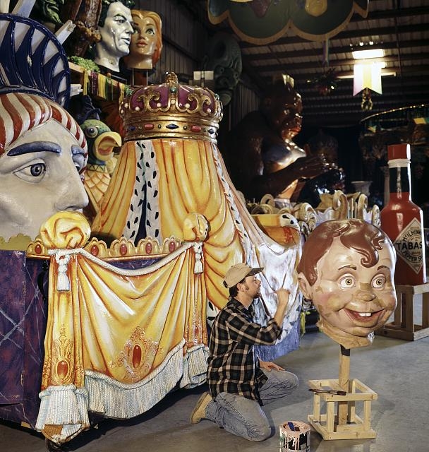 Worker at Mardi Gras World painting floats, New Orleans,...