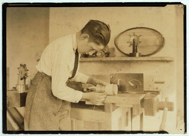 Miscellaneous. Boy at work on coil.