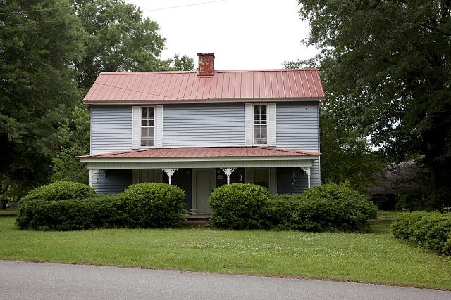 This simple two-story frame house built in the early...