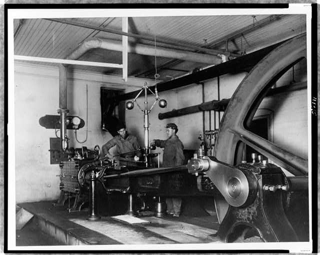 [Two young men training in mechanical(?) engineering at...