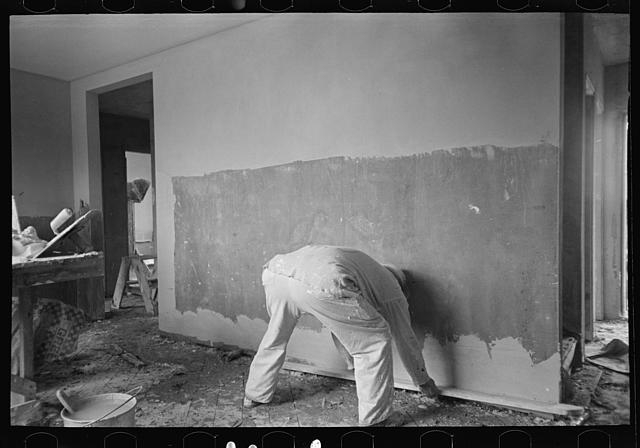 Man plastering wall in Greenhills, Ohio house