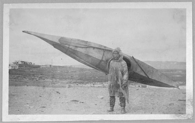 Eskimo carrying kayak