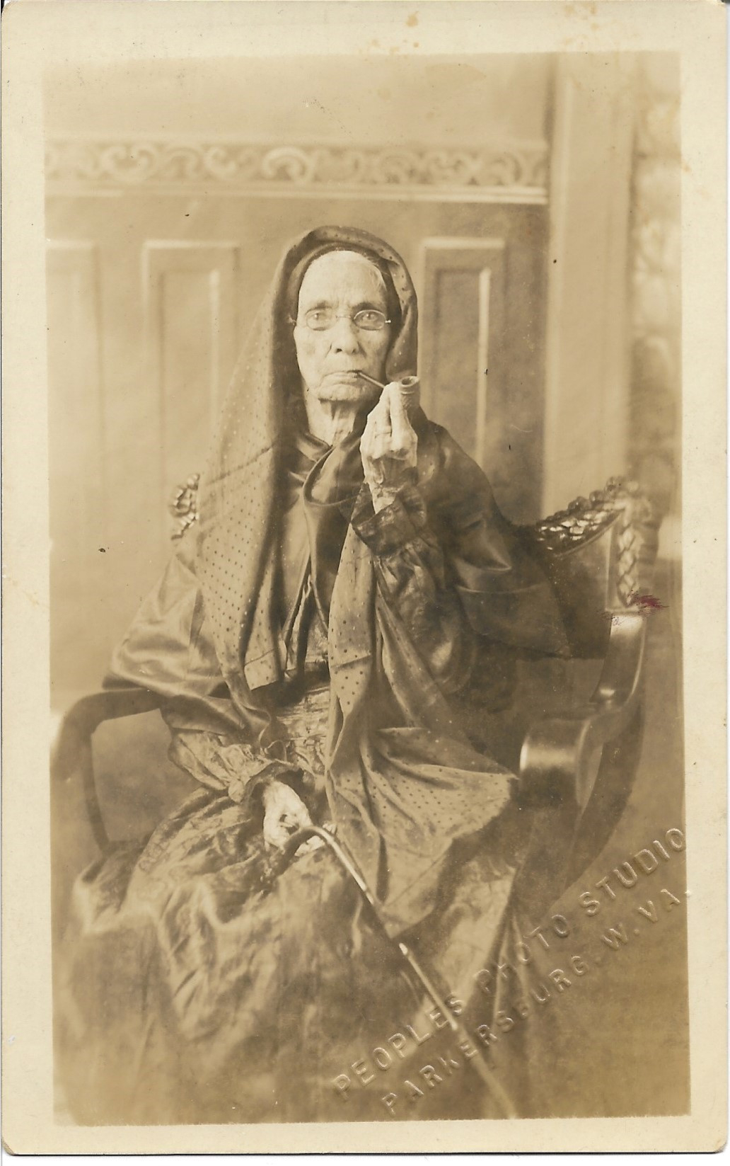 "Old woman smoking a pipe"
