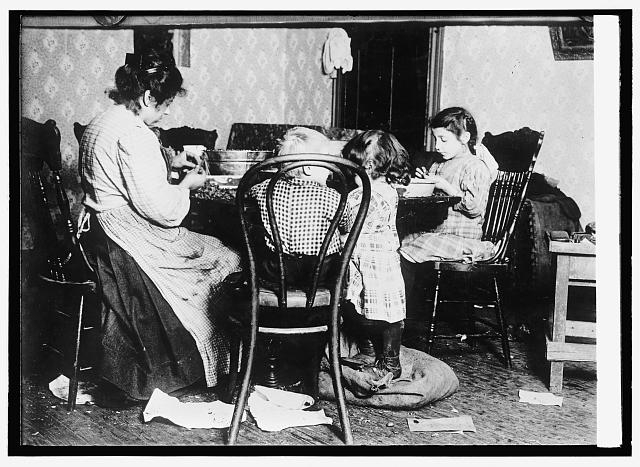 Children 4-6-9, picking nuts in a basement tenement;...