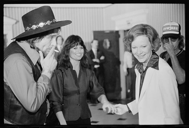 [First Lady Rosalynn Carter with Waylon Jennings, smoking...