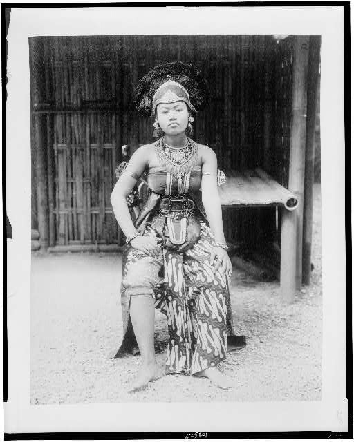 [Female Javanese dancer, full-length portrait, seated, in...