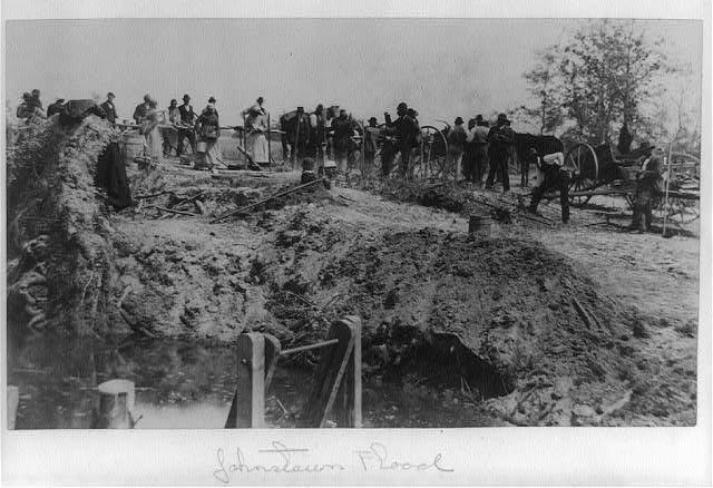 [Afro-Americans with wagons at flood site, some digging,...