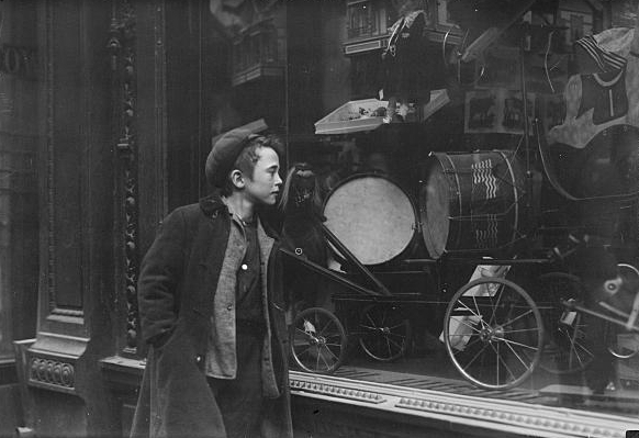 Boy looking at Xmas toys in shop window