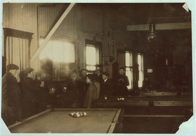 Killing time. Boys and men (many of them workers) hanging...