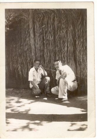 David Hardy, Friend in front of grass hut
