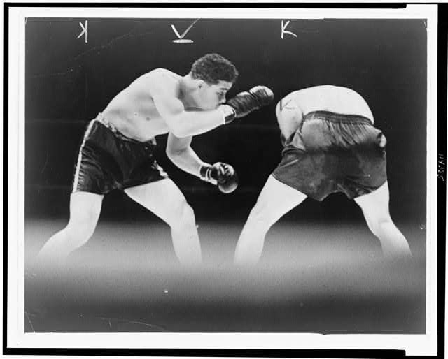 [Joe Louis looks for an opening during boxing match with...