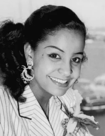 Mona Baptiste in a Pinstripe suite