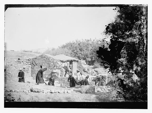 [People including Greek monks? excavating around...