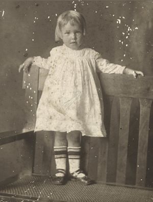 Unknown Child Standing on Bench