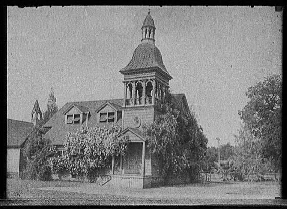 [Church with dormered roof and cupola-topped bell tower]