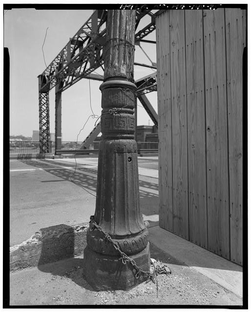 25. Detail of cast iron lamp post base with fluted wooded...