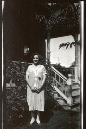 Woman standing in front of house