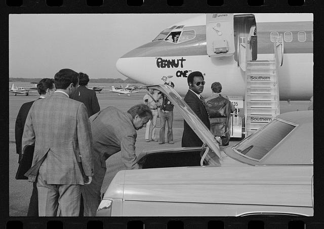 [Jimmy Carter retrieving his luggage from a car before...