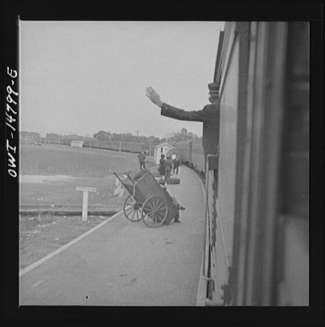 Saint Augustine, Florida. Trainman signalling from a "Jim...
