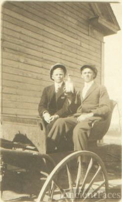 Two men on wagon with bottle