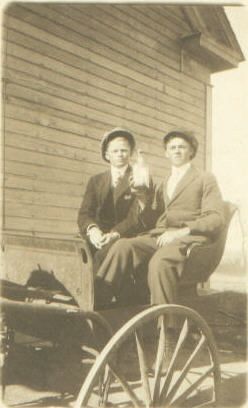 Two men on wagon with bottle