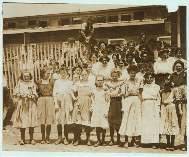 [Groups of girls workers at the gate of the American...