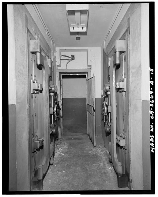 Hallway, closed bank vault door, and opened hallway entry...