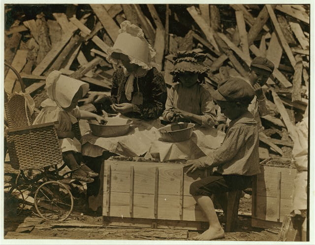 Mother and children hulling strawberries at Johnson's...