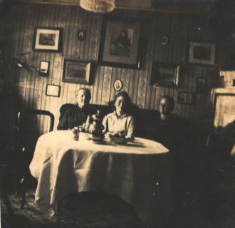 Three people in a dining room Three people in a dining room