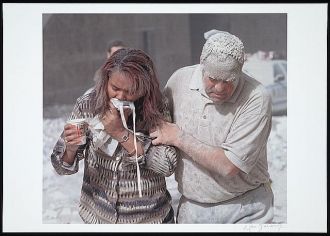 [Man covered with ashes assisting a woman walking and...