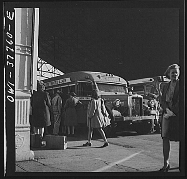 Indianapolis, Indiana. An old-type bus being boarded by...