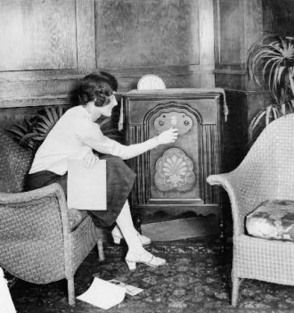 Young woman tuning a radio