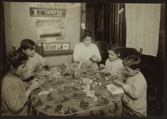 [Woman, two boys, and two girls sitting at a table,...