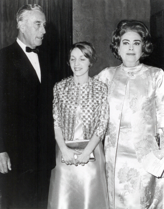 I am in the middle between Lord Mountbatten and Joan Crawford wearing a peach satin gown designed by Cecile Dansky.