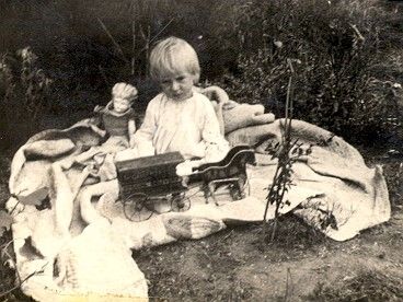 Small child playing with antique toys in Oklahoma