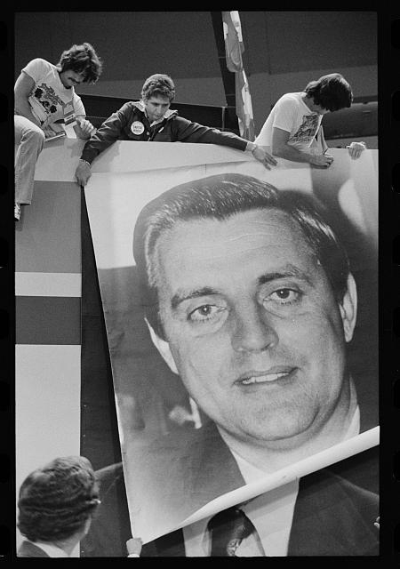 [Raising an enormous photograph of Walter Mondale at the...