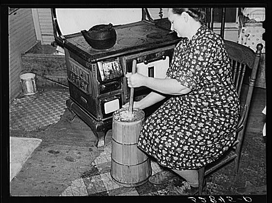 Mrs. Elvin Wilkins (Rosa) churning butter in the kitchen...